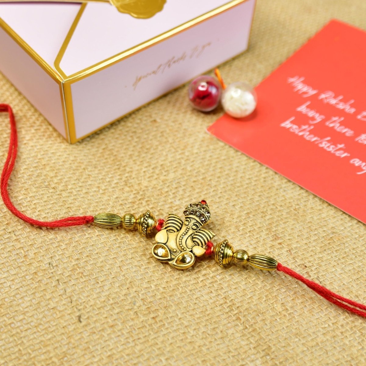 Sowpeace Exquisite Golden Ganesha Rakhi Pack of 1 with Roli Chawal and Greeting card combo for Raksha Bandhan and Gifting - Sowpeace - 