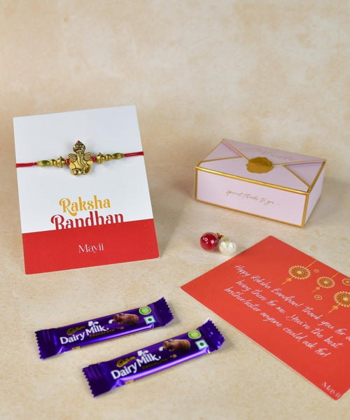 Sowpeace Exquisite Golden Ganesha Rakhi Pack of 1 with Roli Chawal Thali, two Chocolates, and Greeting card combo for Raksha Bandhan and Gifting