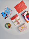 Sowpeace Exquisite Pink Circle Rakhi Pack of 1 with Roli Chawal Thali, Chocolates, Poloroids and Greeting card combo for Raksha Bandhan and Gifting - Rakhi - Sowpeace - Sowpeace Exquisite Pink Circle Rakhi Pack of 1 with Roli Chawal Thali, Chocolates, Poloroids and Greeting card combo for Raksha Bandhan and Gifting - RAK - PINK - HND - P5 - Sowpeace