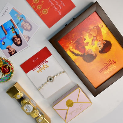Sowpeace Exquisite Swastik Rakhi Pack of 1 with Roli Chawal Thali, Chocolates, Photo Frame, Poloroids and Greeting card combo for Raksha Bandhan and Gifting